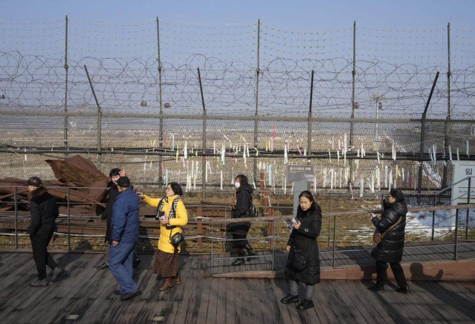 Visitors pass by a wire fence at the Imjingak Pavilion in Paju, South Korea, Wednesday, Jan. 10, 2024. North Korean leader Kim Jong Un has called South Korea "our principal enemy" and threatened to annihilate it if provoked, as he escalates his inflammatory, belligerent rhetoric against Seoul and the United States before their elections this year. (AP Photo/Ahn Young-joon)