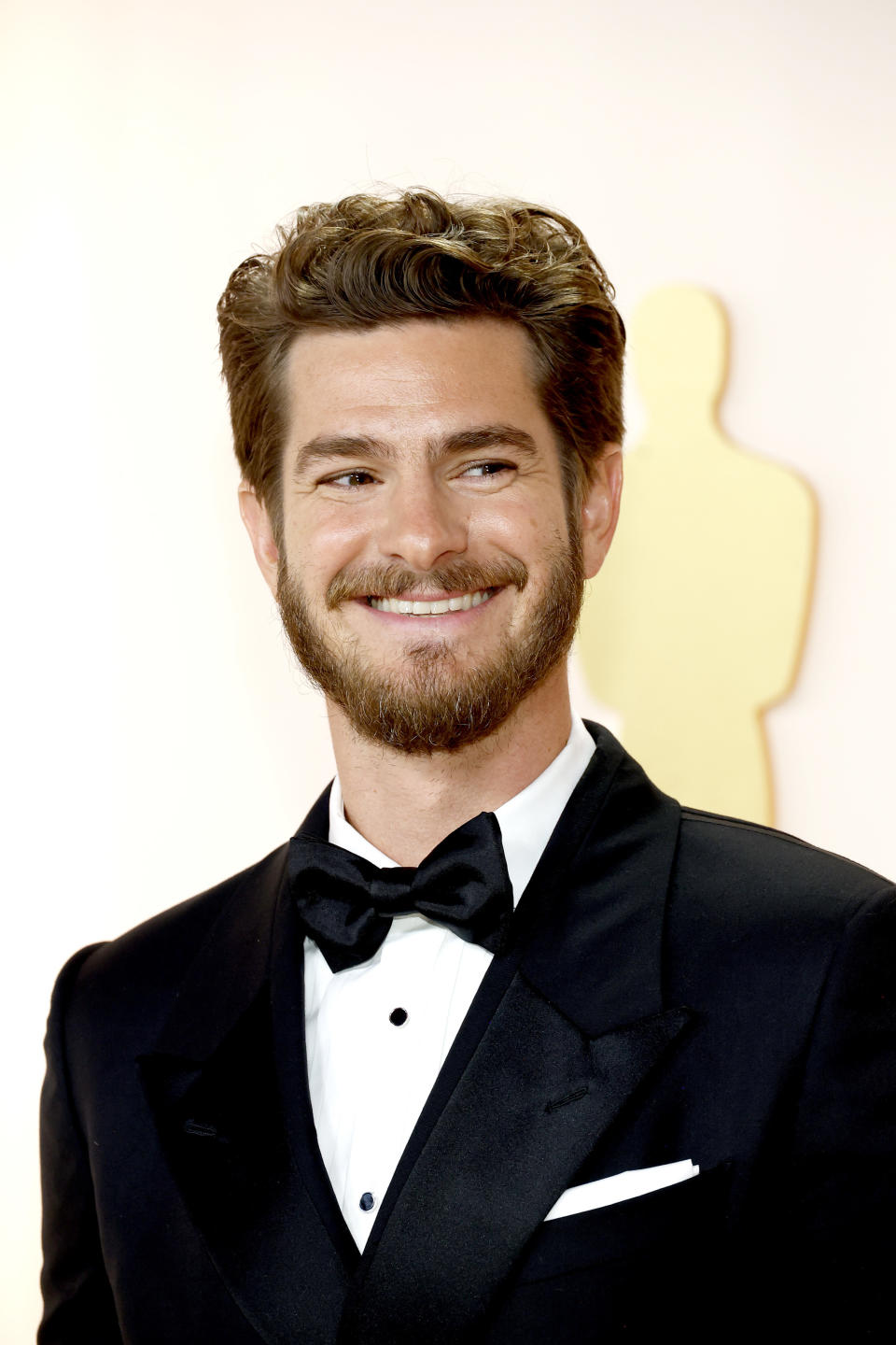 Close-up of Andrew in a suit and tie and smiling