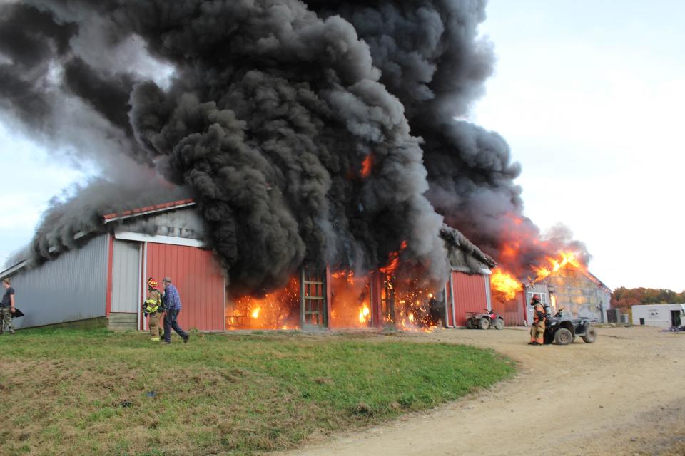 Columns of smoke rise from the flames inside of a barn at Brunton Dairy on Oct. 26, 2023. According to the family farm operators, the milking and bottling production at the farm was destroyed in the fire.