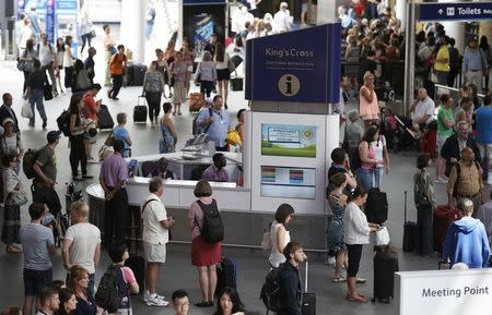 Commuters stop to observe a minute's silence for the victims of the Tunisia terror attack, at King's Cross Station in London, Britain July 3, 2015. Millions of people across Britain held a minute's silence on Friday a week after 30 Britons were killed by an Islamist gunman in Tunisia in the counter's worst loss of life in a militant attack in a decade. REUTERS/Peter Nicholls