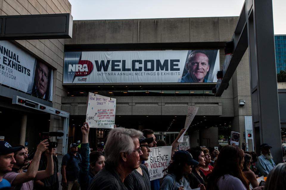 Protesters march to the Kay Bailey Hutchison Convention Center, where the NRA is holding its annual meeting, on&nbsp;Friday.