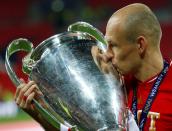 FILE PHOTO: Bayern Munich's Arjen Robben kisses the trophy after beating Borussia Dortmund 2-1 in their Champions League final at Wembley. Robben scored an 89th minute winner to seal Bayern's fifth title in the competition.