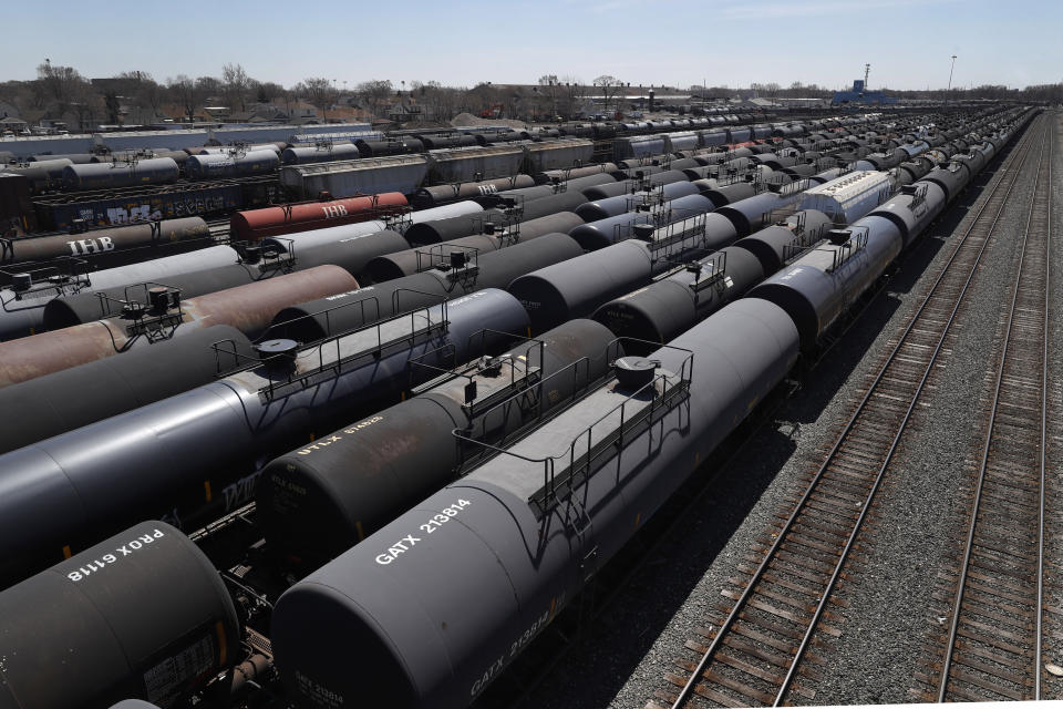 Oil tank train cars sit idle Tuesday, April 21, 2020, in East Chicago, Ind. The world is awash in oil, there's little demand for it and we're running out of places to put it. That in a nutshell explains this week's strange and unprecedented action in the market for crude oil futures contracts, where traders essentially offered to pay someone else to deal with the oil they were due to have delivered next month. (AP Photo/Charles Rex Arbogast)