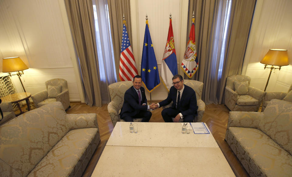 U.S President Donald Trump's envoy for the Kosovo-Serbia dialogue, Ambassador Richard Grenell, left, shakes hands with Serbian President Aleksandar Vucic during a meeting in Belgrade, Serbia, Friday, Jan. 24, 2020. Grenell is meeting Serbian President Vucic in order to move the dialogue and normalize relations between the two sides.(AP Photo/Darko Vojinovic)