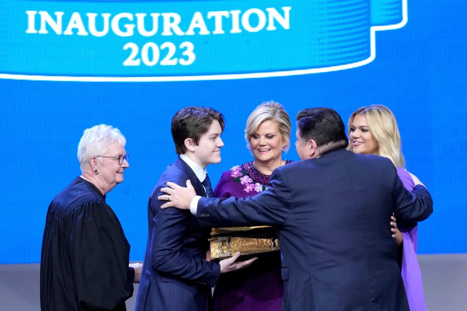 Gov. JB Pritzker, right, celebrates with his family, wife M.K. Pritzker, son Don, and daughter Teddi after taking the oath of office from Illinois Supreme Court Chief Justice Mary Jane Theis during ceremonies Monday in Springfield.