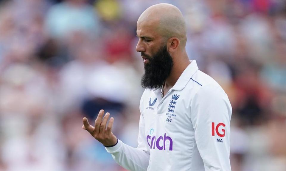 Moeen Ali looks at his injured index finger