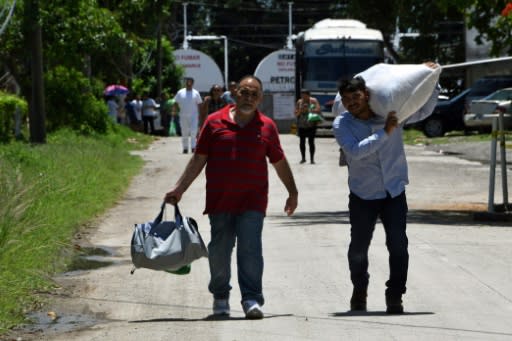 Hondurans deported from the US after trying to cross the border arrive back at the San Pedro Sula airport in Honduras on Friday