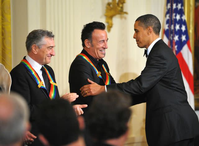 <p>MANDEL NGAN/AFP via Getty</p> Robert De Niro, Bruce Springsteen and Barack Obama during a reception for Kennedy Center Honorees in 2009