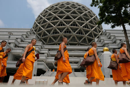 Buddhist Monks from Dhammakaya temple walk past a building inside Dhammakaya temple in Pathum Thani province, Thailand, March 9, 2017. REUTERS/Athit Perawongmetha