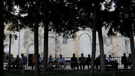 People enjoy in the garden of a mosque in Silvan, a town in Diyarbakir province, Turkey, June 5, 2018. Picture taken June 5, 2018. REUTERS/Umit Bektas