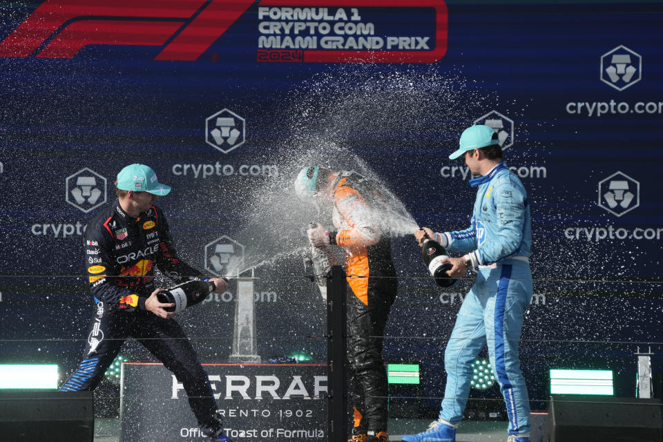 Second place winner, Red Bull driver Max Verstappen, of the Netherlands, left, and third place winner Ferrari driver Charles Leclerc, of Monaco, right, spray champagne on winner, McLaren driver Lando Norris, of Britain, after the Formula One Miami Grand Prix auto race at the Miami International Autodrome, Sunday, May 5, 2024, in Miami Gardens, Fla. (AP Photo/Wilfredo Lee)