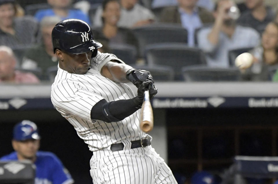 FILE - In this Sept. 14, 2018, file photo, New York Yankees' Andrew McCutchen hits a home run during the fifth inning of a baseball game against the Toronto Blue Jays, at Yankee Stadium in New York. A person familiar with the negotiations tells The Associated Press that All-Star outfielder Andrew McCutchen and the Philadelphia Phillies have agreed to a $50 million three-year contract. The person spoke on condition of anonymity Tuesday, Dec. 11, 2018, because the agreement, which includes a club option for 2022, is subject to a successful physical.(AP Photo/Bill Kostroun, File)