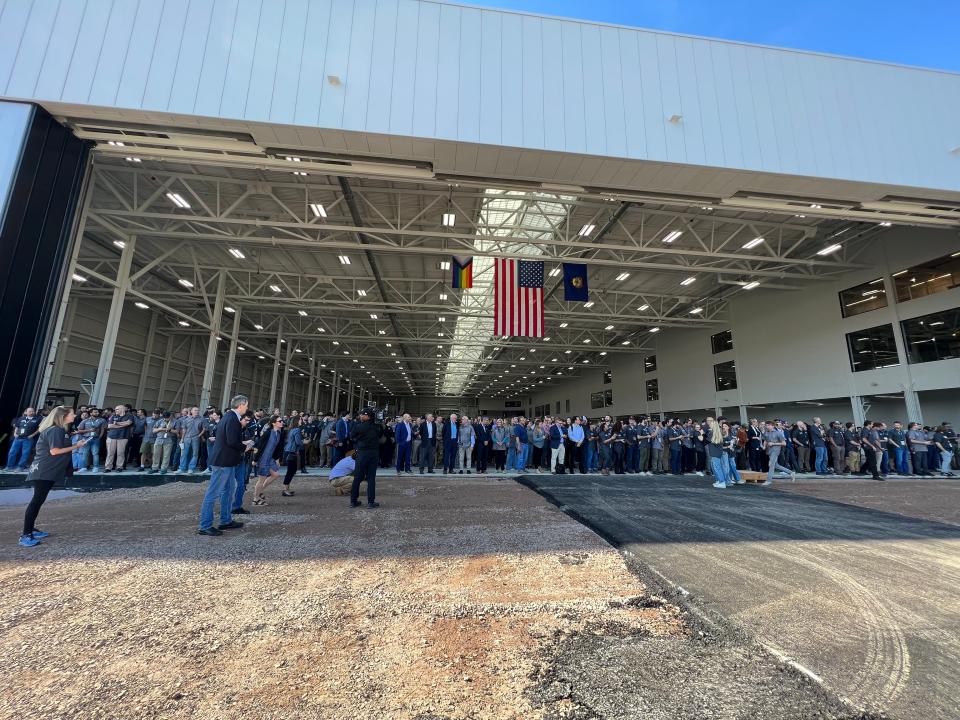 With the hangar doors open, spectators watch as Alia makes several flyovers of Beta's new facility. Beta Technologies opens an electric aircraft production facility at the Patrick Leahy Burlington International Airport in South Burlington on Oct. 2, 2023.