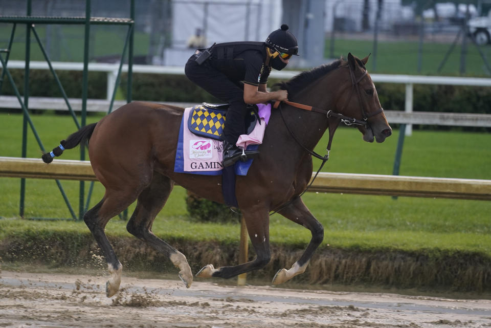 FILE - In this Sept. 2, 2020 file photo, Kentucky Oaks entry Gamine runs during a workout at Churchill Downs in Louisville, Ky. The filly trained by two-time Triple Crown winner Bob Baffert has tested positive in a post-race drug test for the second time this year, making it the third positive test by a horse in Baffert’s stable in the last six months. Craig Robertson, Baffert’s attorney, issued a statement confirming Gamine’s test results after her third-place finish as the 7-10 favorite in the Kentucky Oaks at Churchill Downs on Sept. 4. (AP Photo/Darron Cummings, File)