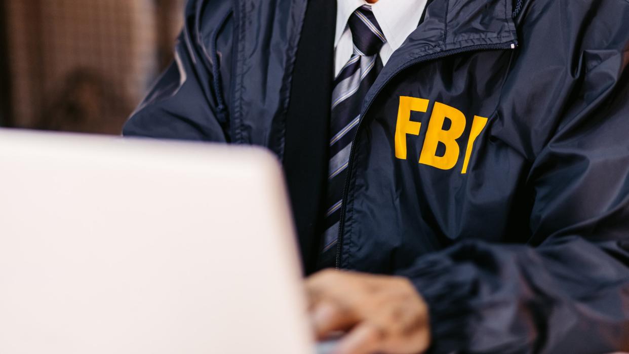  An FBI agent using a comuter. 