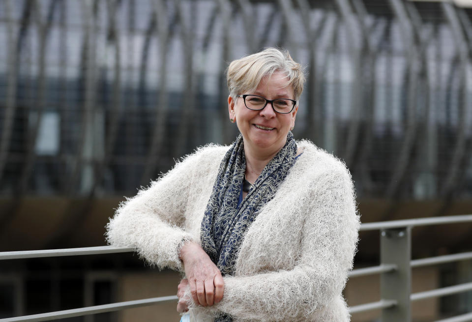 Professor Sharon Peacock poses for a photograph at the Wellcome Sanger Institute that is operated by Genome Research in Cambridge, Thursday, March 4, 2021.Cambridge University microbiologist Sharon Peacock understood that genomic sequencing would be crucial in tracking the coronavirus, controlling outbreaks and developing vaccines, so she began working with colleagues around the country to put together a plan when there were just 84 confirmed cases in the country. The initiative helped make Britain a world leader in rapidly analyzing the genetic material from large numbers of COVID-19 infections, generating more than 40% of the genomic sequences identified to date.(AP Photo/Frank Augstein)