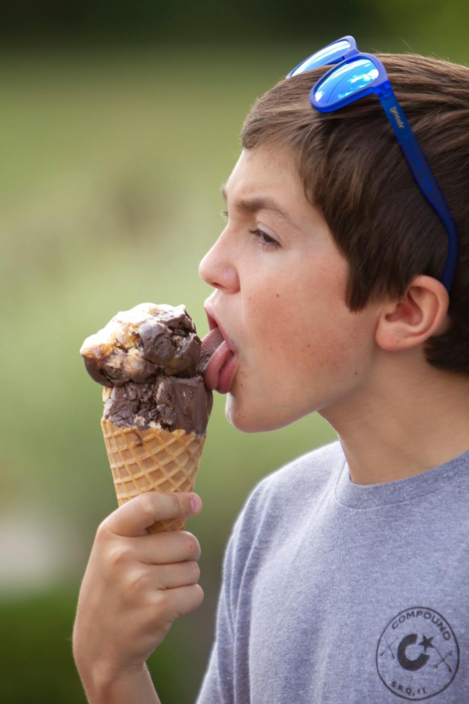 11-year-old Weston Buckley of Brighton enjoys a double scoop of ice cream from Cap'n Frosty in Hamburg Friday, July 2, 2021.