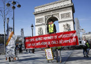 Yellow vest protesters gather at the Arc de Triomphe in Paris, Sunday, Feb. 17, 2019. French yellow vest protesters are marking three months since the kickoff of their anti-government movement, as anti-Semitic remarks by some demonstrators have raised national concern about the movement's ascendant radical fringe. (AP Photo/Thibault Camus)