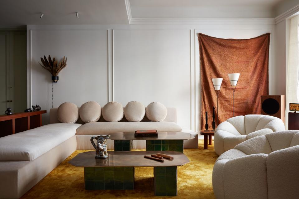 Architect Giancarlo Valle, principal of his eponymous studio in New York City, designed this 1,700-square-foot, two-bedroom NoHo apartment for a young creative couple. In the living room, Valle paired this slim armless sectional (his own design, upholstered in ecru Italian mohair) with a set of voluminous Pierre Paulin chairs from Ralph Pucci. The coffee tables, made of brass plates atop ceramic blocks, were also designed by Valle. An Italian silk tapestry from Paula Rubenstein hangs on the back wall. In typical Valle fashion, it creates asymmetry while also acting as a balancing element.