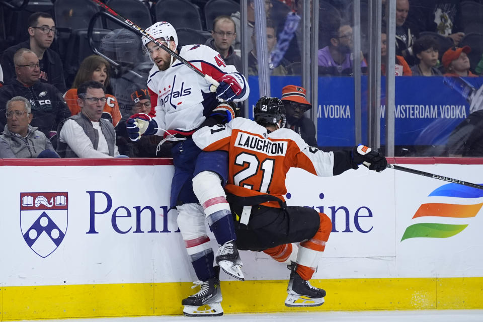 Washington Capitals' Tom Wilson, left, and Philadelphia Flyers' Scott Laughton collide during the first period of an NHL hockey game, Tuesday, April 16, 2024, in Philadelphia. (AP Photo/Matt Slocum)