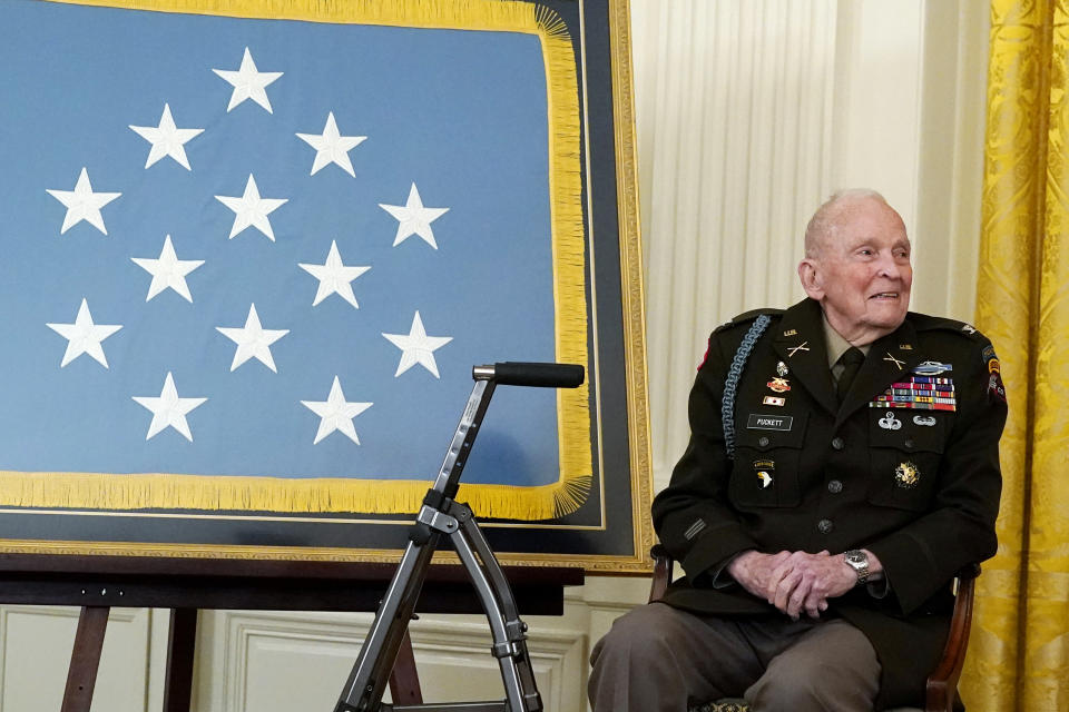 FILE - Retired U.S. Army Col. Ralph Puckett listens to President Joe Biden speak during a Medal of Honor ceremony in the East Room of the White House, Friday, May 21, 2021, in Washington. Puckett, a retired Army colonel awarded the Medal of Honor seven decades after he was wounded leading a company of outnumbered Army Rangers in battle during the Korean War, died peacefully Monday, April 8, 2024, at his home in Columbus, Ga., according to the Striffler-Hamby Mortuary, which is handling funeral arrangements. He was 97. (AP Photo/Alex Brandon, File)