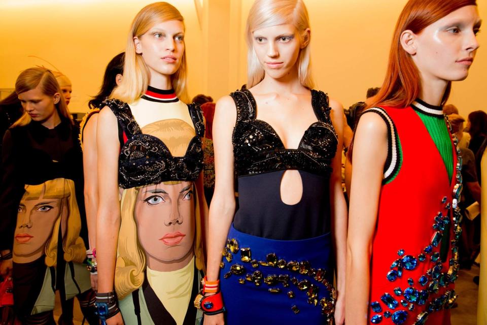 Like the bold color blocking in Miuccia's Spring 2014 collection, Prada’s model gang sat for saturated, single-tone dye jobs that made highlights seem obsolete. Auburn, raven, and peroxide manes were pinned back and paired with bleached brows for a wholly contemporary look.