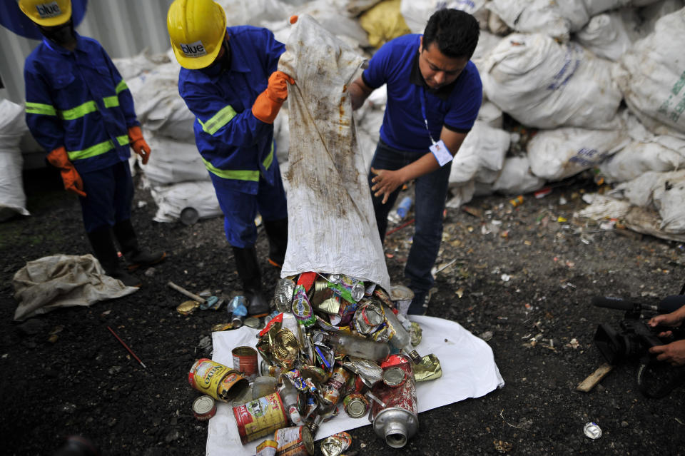 Staff and Workers from the recycle company Blue Waste 2 Value showing the waste garbage's towards media collected from Mount Everest and Base Camp in Kathmandu, Nepal on Wednesday, June 05, 2019. Clean-up Campaign 2019 on Mount Everest removes 24,000lbs of rubbish and four dead bodies. (Photo by Narayan Maharjan/NurPhoto via Getty Images)