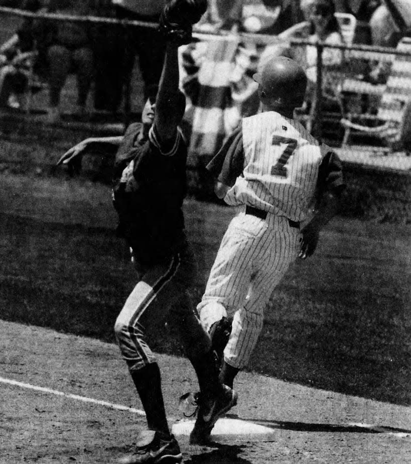 Edison’s Jerry Lithgow reaches first safely on Saturday, May 29, 1999, as Bishop Ahr’s Erik Kutz takes the high throw.