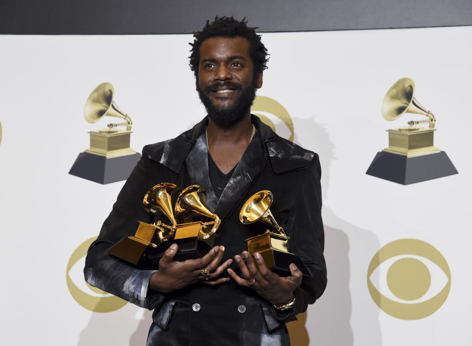 Gary Clark Jr. poses in the press room with the awards for best rock song, best rock performance and best contemporary blues album for "This Land", at the 62nd annual Grammy Awards at the Staples Center on Sunday, Jan. 26, 2020, in Los Angeles. (AP Photo/Chris Pizzello)