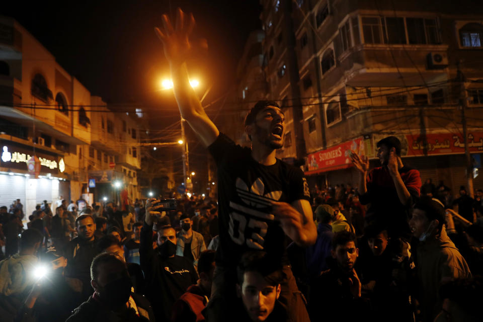 Protesters chant anti Israel slogans during a protest in solidarity with fellow Palestinian worshippers in Jerusalem, at the main street of Shati refugee camp in Gaza City, Saturday, April 24, 2021. (AP Photo/Adel Hana)