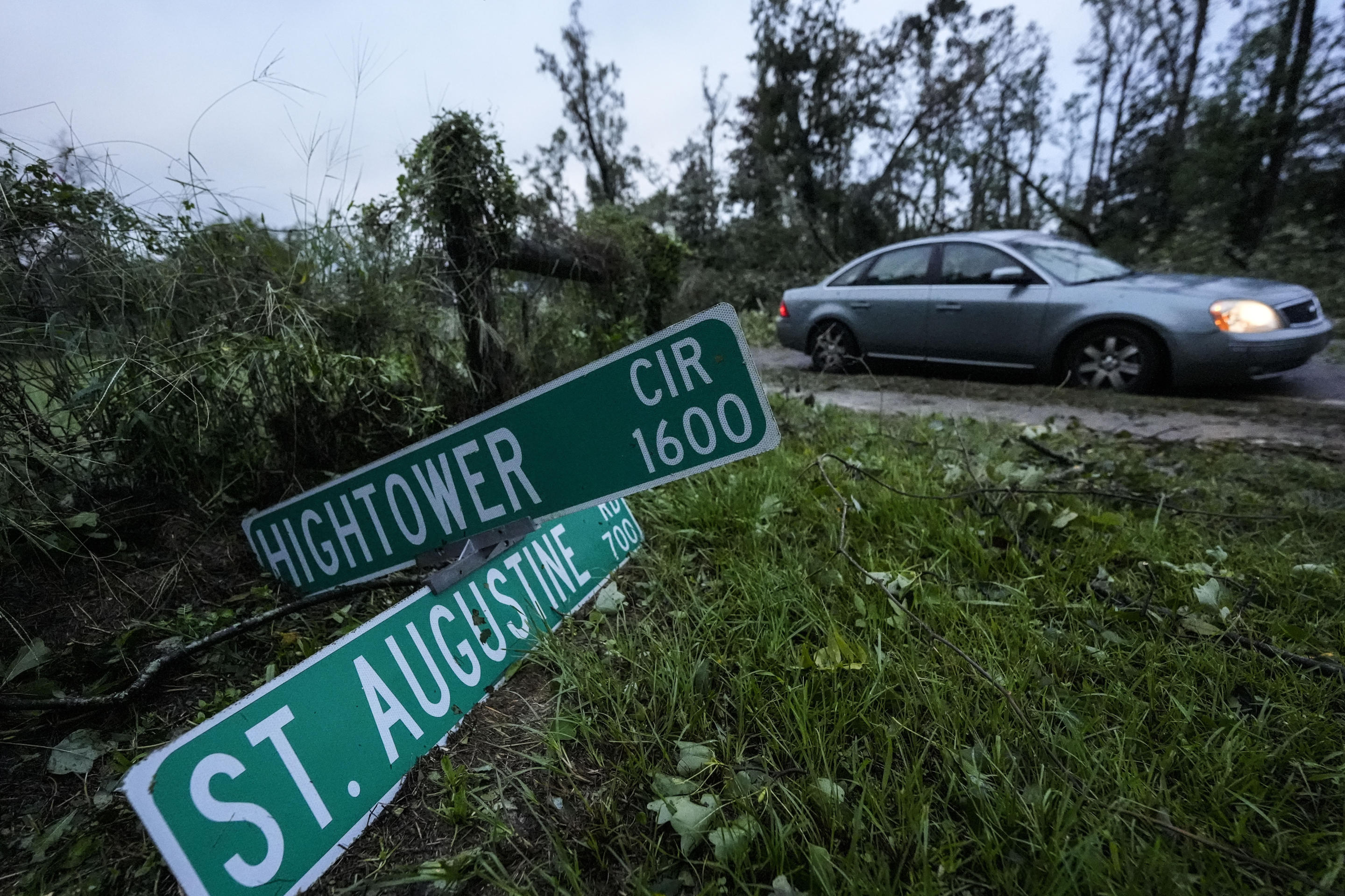 Vehicles move slowly around trees that have fallen after Hurricane Helene moved through the area in Valdosta, Georgia, on Friday.