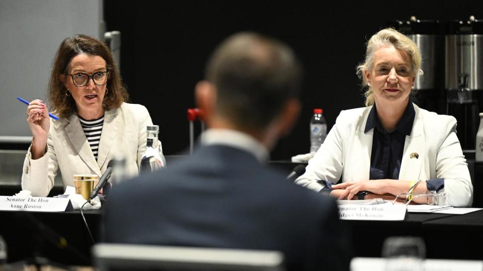 Senators Anne Ruston (left) and Bridget McKenzie (right) look on