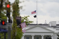 The American flag flies at half-staff over the White House in Washington, Friday, April 16, 2021. (AP Photo/Susan Walsh)