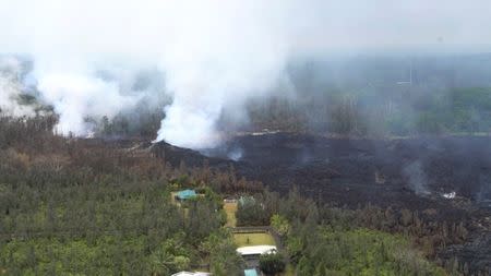 Molten rock flows and burst to the surface, threatening homes in a rural area in this still image from an aerial video taken from a Hawaii Army National Guard a week after the eruption of the Kilauea volcano, in Pahoa, Hawaii, U.S., May 10, 2018. Courtesy Andrew Jackson/Hawaii DoD/Handout via REUTERS