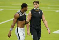 Las Vegas Raiders linebacker Javin White, left, and linebacker Tanner Muse speak during an NFL football training camp practice Friday, Aug. 28, 2020, in Las Vegas. (AP Photo/John Locher)