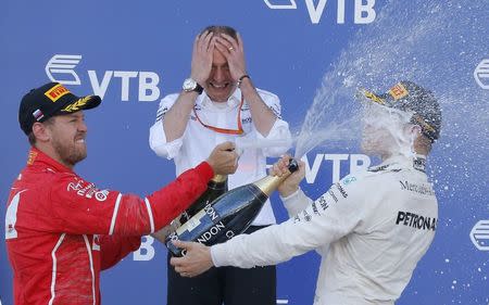 Formula One - F1 - Russian Grand Prix - Sochi, Russia - 30/04/17 - Winner and Mercedes Formula One driver Valtteri Bottas (R) of Finland and second-placed Ferrari Formula One driver Sebastian Vettel of Germany spray champagne on the podium. REUTERS/Maxim Shemetov