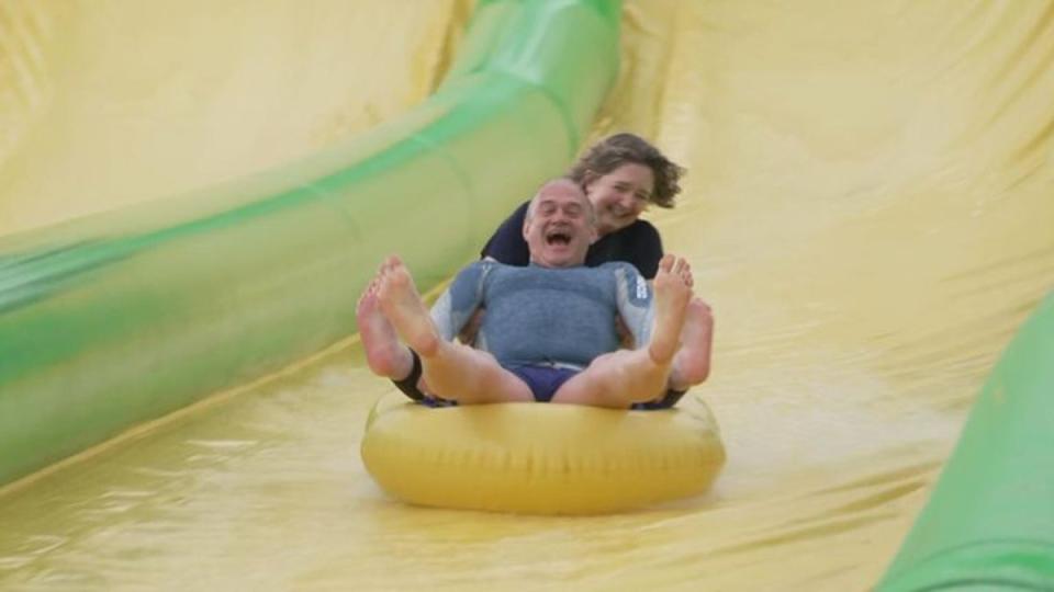 Sir Ed joins Frome and East Somerset Lib Dem hopeful Anna Sabine in sliding down the Slip n Slide waterslide in Beckington, just outside Frome, Somerset (Sky News)