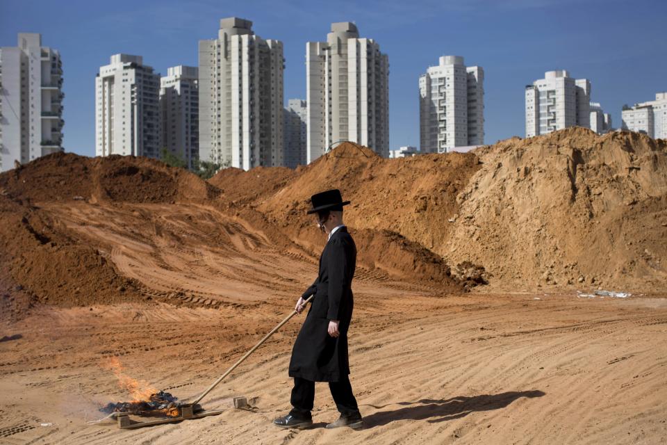 An ultra-Orthodox Jewish youth burns leavened items in final preparation for the Passover holiday in the ultra-Orthodox Jewish town of Bnei Brak, near Tel Aviv, Israel, Monday, April 14, 2014. Jews are forbidden to eat leavened foodstuffs during the Passover holiday that celebrates the biblical story of the Israelites' escape from slavery and exodus from Egypt. (AP Photo/Oded Balilty)