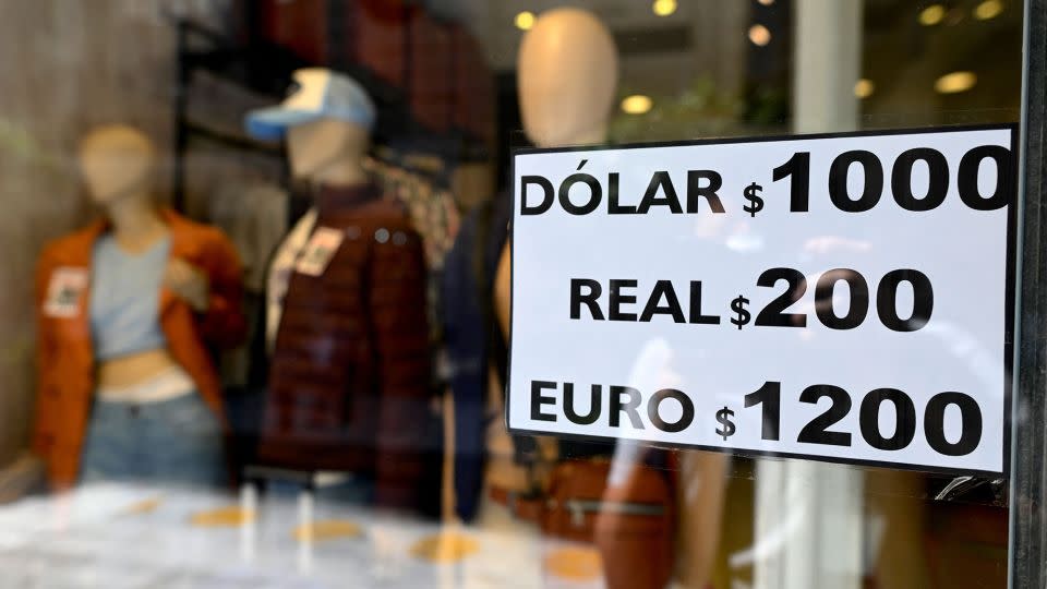 A sign with exchange currency values of the unofficial so-called "Blue Dollar" of the parallel market is displayed in the window of a store in Buenos Aires on October 10, 2023.  - Luis Robayo/AFP/Getty Images