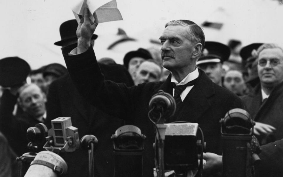 Neville Chamberlain, the British prime minister, makes his 'peace in our time' address at Heston Airport after meeting Hitler  in Munich