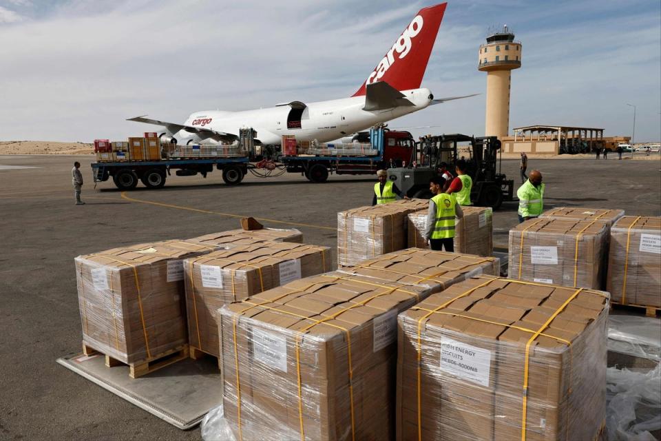 Workers unload humanitarian aid at Egypt's al-Arish Airport on Wednesday (AFP via Getty Images)