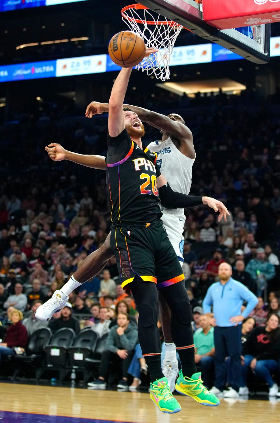 Grizzlies center Bismack Biyombo (18) blocks a shot from Suns center Jusuf Nurkic (20) during a game at the Footprint Center in Phoenix on Dec. 2, 2023.