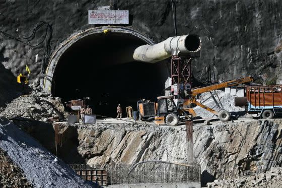 Security personnel stand at an entrance of the under construction road tunnel, days after it collapsed in the Uttarkashi district of India.<span class="copyright">Arun Sankar—AFP via Getty Images</span>