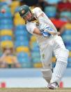 Australian cricketer Ryan Harris hits a boundary off West Indies bowler Devendra Bishoo during the fourth day of the first-of-three Test matches between Australia and West Indies at the Kensington Oval stadium in Bridgetown on April 10, 2012. AFP PHOTO/Jewel Samad (Photo credit should read JEWEL SAMAD/AFP/Getty Images)