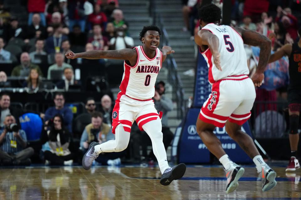 Mar 14, 2024; Las Vegas, NV, USA; Arizona Wildcats guard Jaden Bradley (0) and guard KJ Lewis (5) celebrate against the Southern California Trojans in the second half at T-Mobile Arena. Mandatory Credit: Kirby Lee-USA TODAY Sports