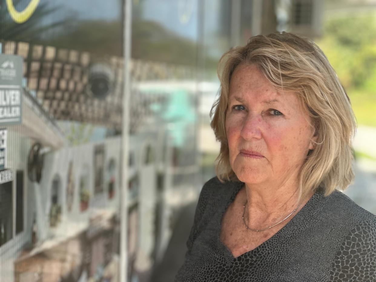 Elsa Wittbold of Port Orange stands outside the locked doors of Serene Pavers & Streetscapes Inc., a New Smyrna Beach business she paid about $4,000 for a backyard paver job she says the company never started. She is looking into filing a police complaint.