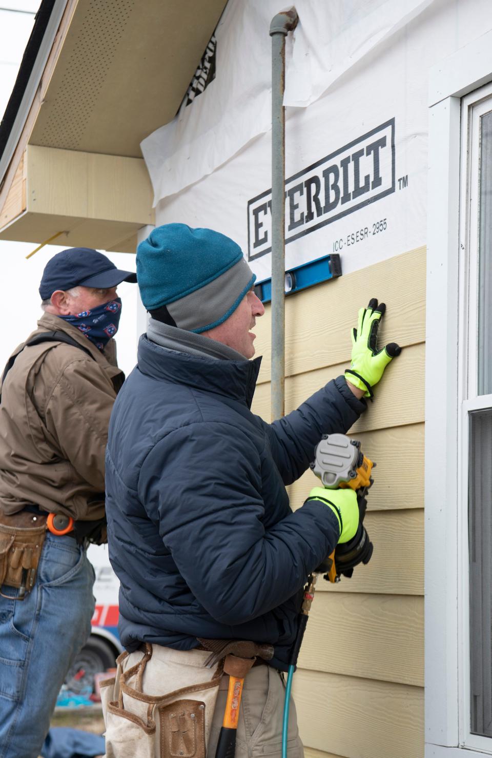 Steve LaForge and Alan Sowell work to repair the tornado damaged home of Daniel McDaniel on Friday, Feb. 12, 2021 in Nashville, Tenn.