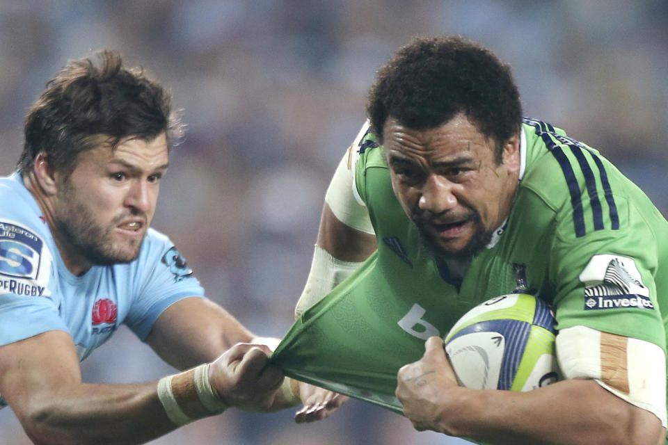 FILE - In this June 27, 2015, file photo, Waratahs' Adam Ashley-Cooper, left, tugs on the shirt of Highlanders' Nasi Manu during their Super Rugby semifinal match in Sydney. The 31-year-old Manu is on the brink of playing his first game at the World Cup, and first since being diagnosed with testicular cancer. He missed all of 2018 and feared for his life, not just his career, while having to undergo emergency surgery and months of chemotherapy. (AP Photo/Rick Rycroft, File)