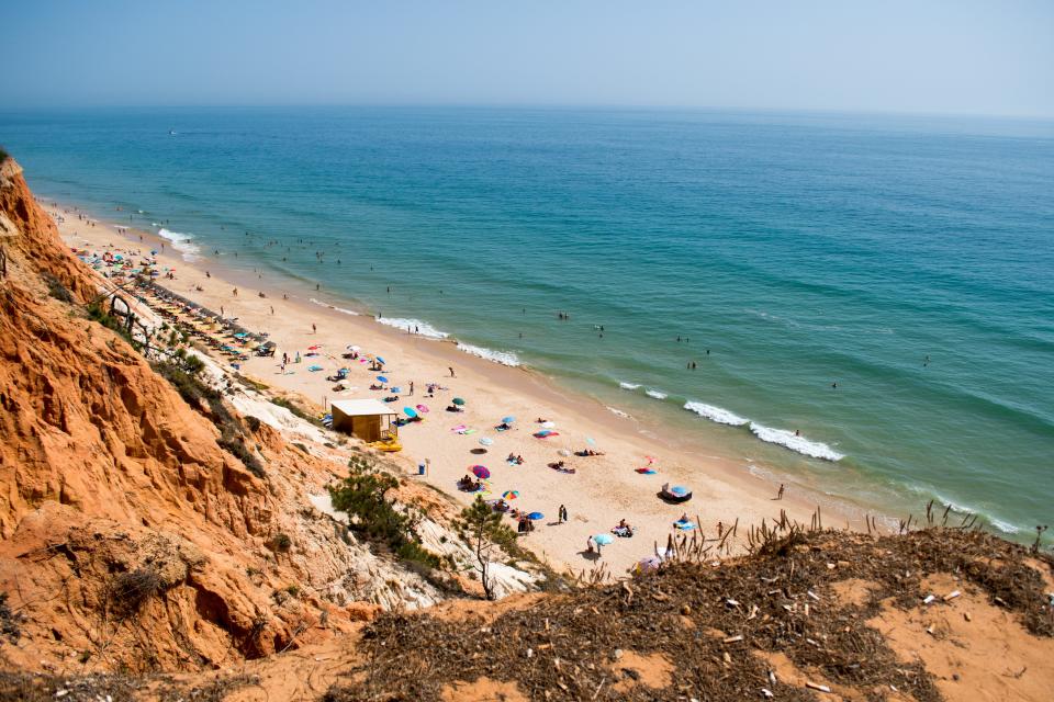 Praia da Falésia boasts dramatic red cliffs, golden sands, and azure waters, making it one of Portugal's most picturesque beaches.