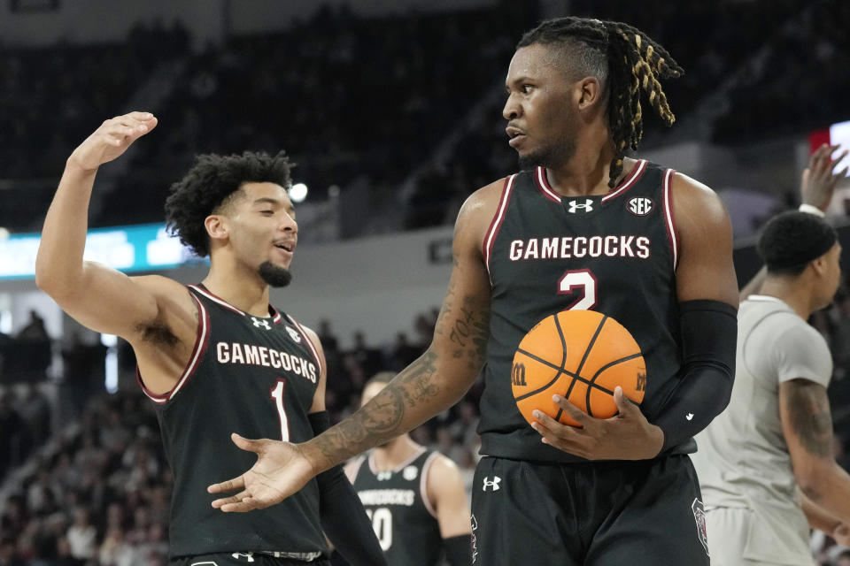 South Carolina forward B.J. Mack (2) is congratulated by guard Jacobi Wright (1) for drawing a Mississippi State foul during the first half of an NCAA college basketball game, Saturday, March 9, 2024, in Starkville, Miss. South Carolina won in overtime 93-89. (AP Photo/Rogelio V. Solis)